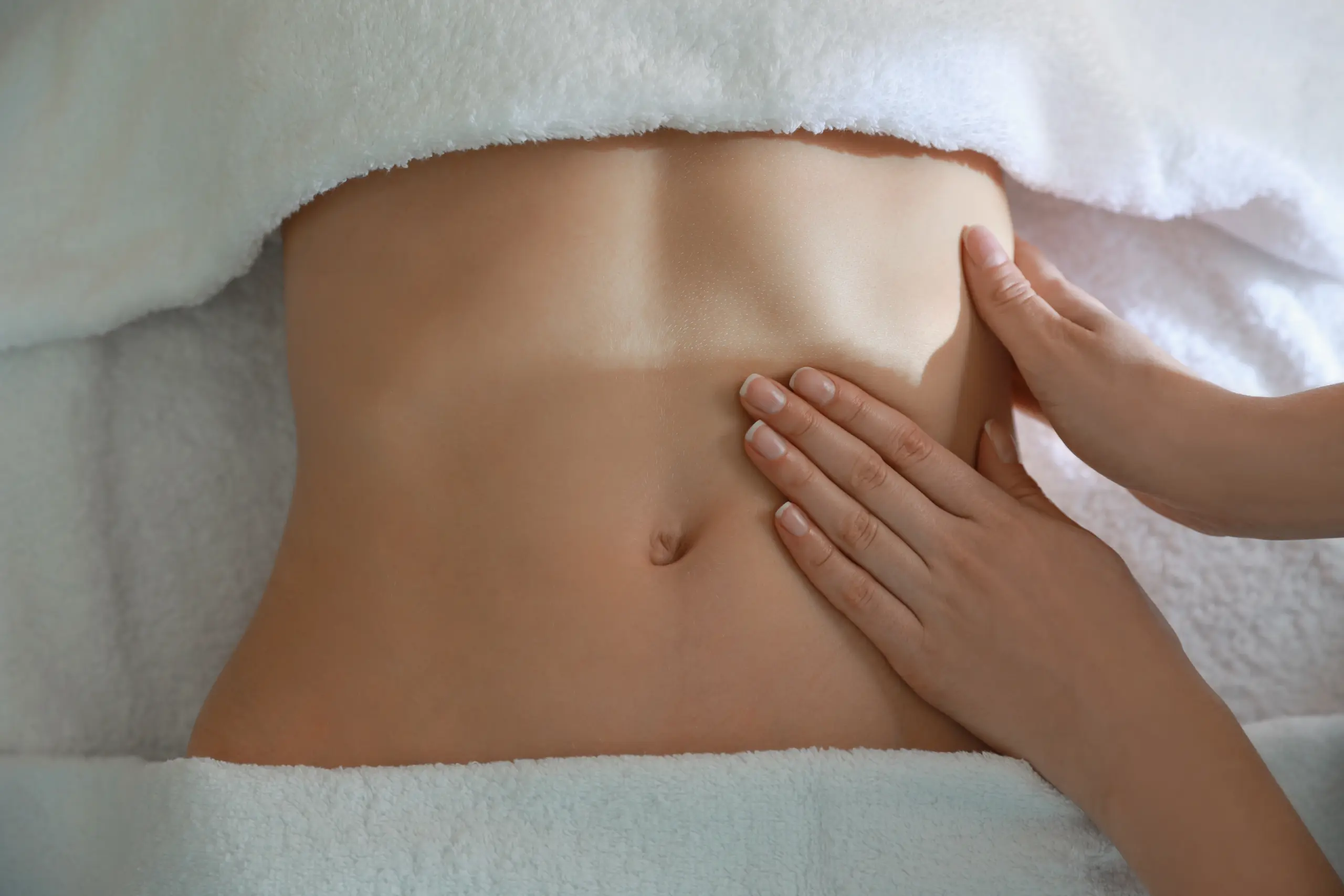 Woman receiving professional belly massage